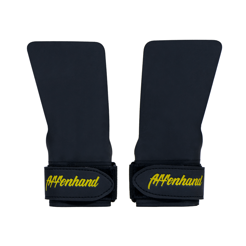 affenhand-no-chalk-grips-schwarz-bester-halt Zwei schwarze Affenhand No Chalk Grips mit gelbem Logo.