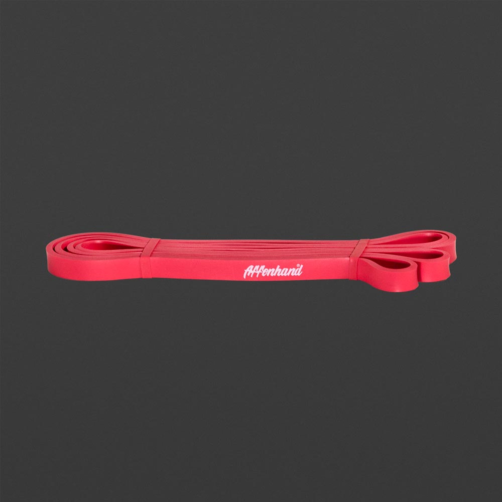 Rotes Affenhand Widerstandsband mit weißem Logo auf dunklem Hintergrund.