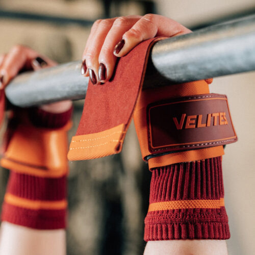 Athlet macht Klimmzug mit orangenen Velites Handschutz